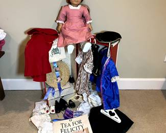 C23 - $450. American Girl Doll Felicity. Includes Christmas Gown & Stomacher, Spring Gown with Pinner Apron & Pompon, Felicity’s Summer Outfit, Cardinal Cloak, Nightgown, Cap & Mules, Work Gown, Riding Habit & Hat, Felicity’s Rose Garden Gown, Fashion Doll along with accessories. Trunk is NOT authentic pleasant company.