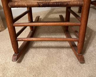 B47 - $50. Ladder Back Rocking Chair. Measures 18" wide x 15" deep x 34.5" tall.