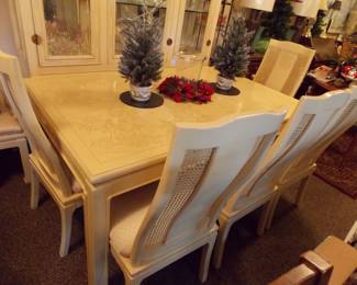 Cream color table and 6 chairs and 2 leaves. Has matching hutch