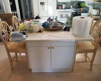 Kitchen features an island. Four bar stools