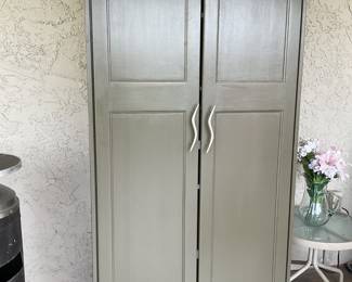 Green storage cabinet being used outdoor on patio