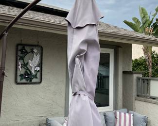 Offset umbrella shown closed, note tear in fabric can be stabilized but opens and closes well as is