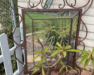 Ornate metal mirror is great garden decor