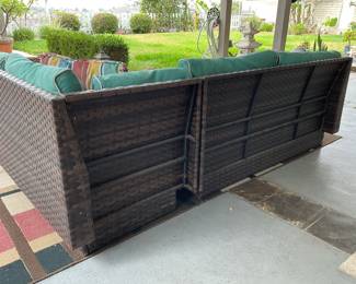 Back side of wicker patio set, sold as set, note two sections for sofa