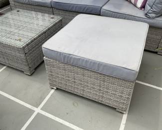 Matching outdoor grey woven ottoman with cushion