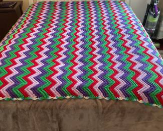 A MOD afghan on the double full size bed headboard, mattress separately