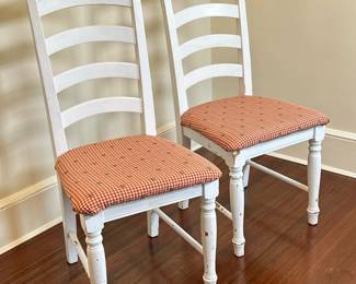 (2pc) Farmhouse Style Ladder-Back Chairs | Vintage farmhouse-style ladder-back wooden chairs, painted white with red upholstered seats. - h. 38.5 x w. 14.5 x d. 18 in