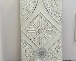 Decorative Coat Hanger/Wall Hook | Decorative coat hanger/wall hook with an ornate sunburst-like central motif, surrounded by textured patterns of raised dots and curved lines, with an elegant glass knob. - h. 11 x w. 6 in