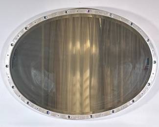 Art Deco Style Oval-Shaped Wall Mirror | Art Deco style, oval-shaped wall mirror with a metallic frame accented by gemstones. Resembles a porthole window on a sea or air vessel. - h. 27.5 x w. 37 in