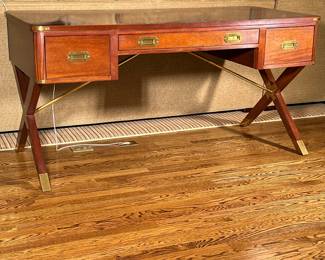 Hickory Chair Co. Campaign Desk | Hickory Chair Company (Hickory, North Carolina) "Asheworth" campaign desk, designed by Suzanne Kasler as indicated by the plaque underneath, features a modern take on French design, with classic brass hardware and crossed legs. - h. 30.5 x w. 60 x d. 28 in