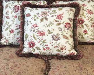 (3pc) Throw Pillows - Red & White Florals | Three square reversible throw pillows with red floral motifs on a white background and brown fringed trim, with a green silky pattern on the backside. - h. 19 x w. 19 in