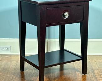 Durham Furniture End Table | Durham Furniture (West Durham, Ontario) "Manhattan Collection" end table in a red/black "cabernet" finish with one drawer, with a routed background behind the brushed nickel drawer pull. - h. 27 x w. 20 x d. 17 in