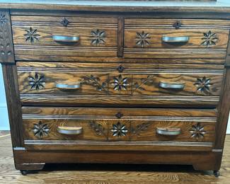 Four-Drawer Oak Dresser | Vintage (early 20th century) oak dresser with a rich dark finish, floral carvings, metal handles, and four drawers (two shorter above two longer). - h. 31 x w. 39.25 x d. `17 in