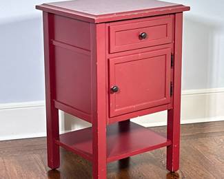 Two-Drawer Painted Side Table - Cranberry | Wooden side table painted red with flat top, one drawer and one cabinet door with black knobs, an open bottom shelf, and a worn finish that adds rustic character. - h. 29 x w. 19 x l. 17 in