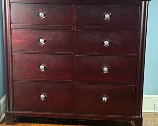 Durham Furniture Dressing Chest | Durham Furniture (West Durham, Ontario) "Manhattan Collection" dressing chest in a red/black "cabernet" finish with eight drawers, each with a routed background behind each brushed nickel drawer pull. - h. 48.5 x w. 52 x d. 20 in