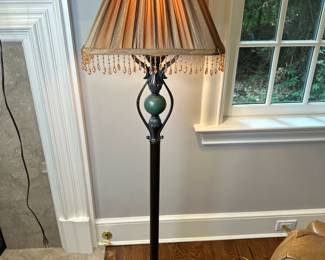Art Deco Style Wrought Iron Floor Lamp | Vintage (late 20th century) Art Deco style wrought iron floor lamp with green stone insert and pleated lampshade with beaded fringe. - h. 59 x dia. 12 in