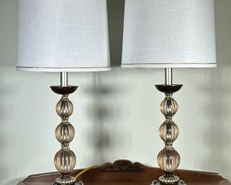 (2pc) Stacked Crystal Sphere Table Lamps | Vintage table lamps, featuring elegant lampposts composed of three stacked crystal spheres, topped with white lampshades accented by gold trim. Wood base - h. 29 x w. 11 in