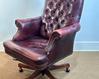 Burgundy Leather Office Chair | Vintage burgundy "Senator's" or "Captain's" leather office chair with tufted button design on its high backrest, nailhead trim along its bottom, and wooden legs on caster wheels that also allow for swivel and tilt movements. - h. 42 x w. 29 x d. 30 in