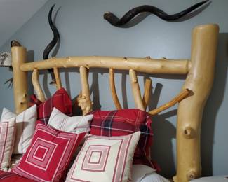 This bed was custom-made in Colorado . Look at the posts. It is just breathtaking. The snake-like elements are horns. Wow!