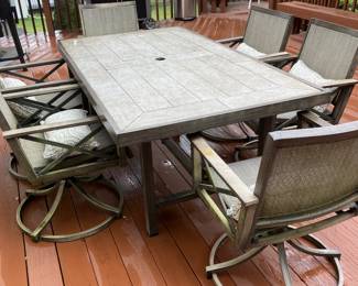 Outdoor dinning table   Swivel rocker chairs 