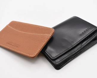 pair of slim wallets-one is Fossil and one is Dooney & Bourke