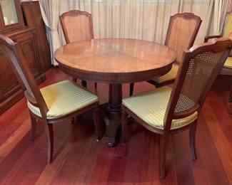 Round Wooden Dining Table with Cane-Backed Chairs