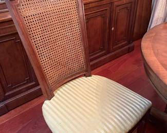 Round Wooden Dining Table with Cane-Backed Chairs