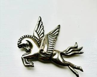 large silver pegasus pin.