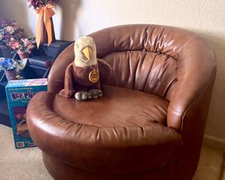 Brown leather swiveling lounge chair 