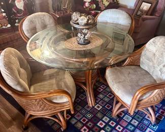 Round glass dining table with 4 wicker chairs