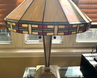 Mission style/prairie school influence by Frank Lloyd Wright and the mission/Stickley style. Stained glass with a geometric pattern bronze hardware two pull strings.