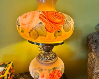 vintage gone with the wind, hurricane style parlor, lamp, hand painted floral design glass globe. The metal work is between 1940s and 1970s. This is a reproduction.