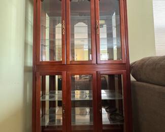 Cherry and glass China cabinet. Four doors electrical lights.