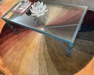 raw iron and rectangular Glass Table, large round hombre rug.