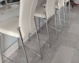 White Leather Bar Stools. Backs recline for comfort