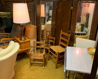 a corner of the basement; wooden chairs