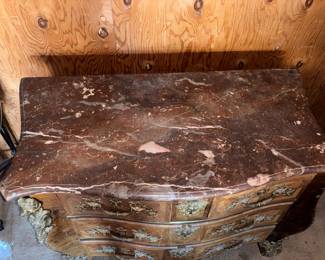 19th Century French Regence-Style Kingwood Commode with Ormolu Mounts



Condition: Very Good | Reserve Price: $399 | Estimated Restored Value: $2,500–$4,000



This elegant French Regence-style commode is a true antique treasure from the 19th century. Crafted in fine kingwood veneer and mounted with gilded bronze ormolu figures and scrolls, it features dramatic serpentine lines, three spacious drawers, and a beautifully contoured original marble top.