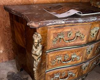 19th Century French Regence-Style Kingwood Commode with Ormolu Mounts

Condition: Very Good | Reserve Price: $399 | Estimated Restored Value: $2,500–$4,000



This elegant French Regence-style commode is a true antique treasure from the 19th century. Crafted in fine kingwood veneer and mounted with gilded bronze ormolu figures and scrolls, it features dramatic serpentine lines, three spacious drawers, and a beautifully contoured original marble top.