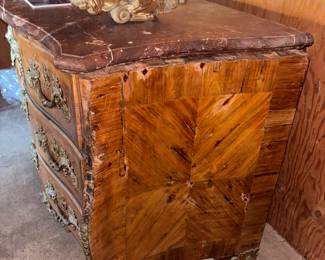 19th Century French Regence-Style Kingwood Commode with Ormolu Mounts



Condition: Very Good | Reserve Price: $399 | Estimated Restored Value: $2,500–$4,000



This elegant French Regence-style commode is a true antique treasure from the 19th century. Crafted in fine kingwood veneer and mounted with gilded bronze ormolu figures and scrolls, it features dramatic serpentine lines, three spacious drawers, and a beautifully contoured original marble top.
