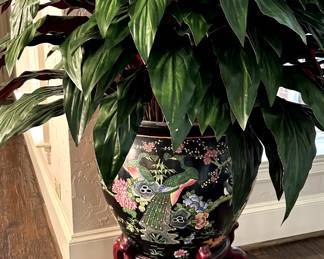 Large plant with Asian influence pot and stand.