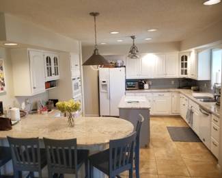 Kitchen features an island. 6 bar stools available