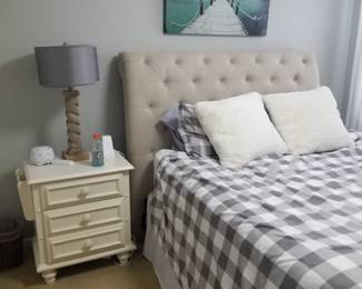 Queen bed; nightstand; table lamp