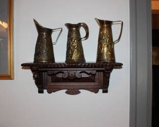 Shelf and Brass Pitchers