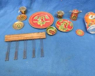 Lot 74. Pieces from a child's metal play set and an antique chalk holding staff line marker used by music teachers