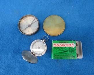 Lot 59. Compass in a brass case and one in its original box from Jack's Outlet in Anoka
