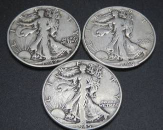 Lot 245. Three walking Liberty Half Dollars: 1928 P, 1942 P, and 1945 P