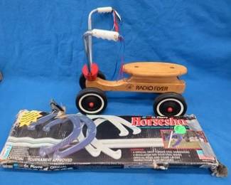 Lot 204. St. Pierre horseshoe set and a sit and scoot Radio Flyer