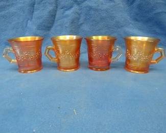Lot 188. Four Matching marigold colored carnival glass handled cups.