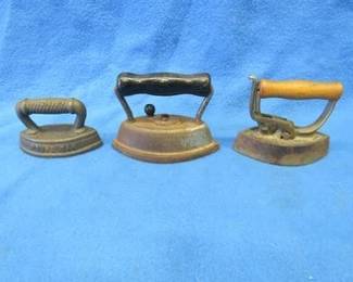 Lot 20. Three small sad irons. One with advertising.
