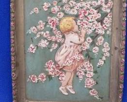 Lot 236. Chalkware relief of toddler and apple blossoms